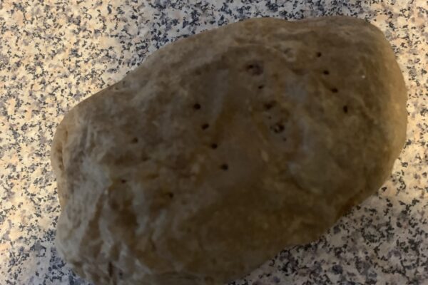 A potato sitting on a counter.