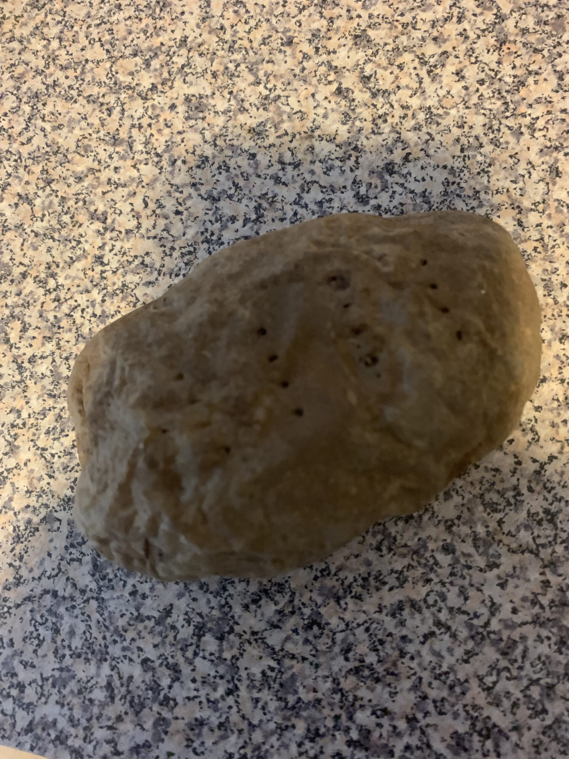 A potato sitting on a counter.