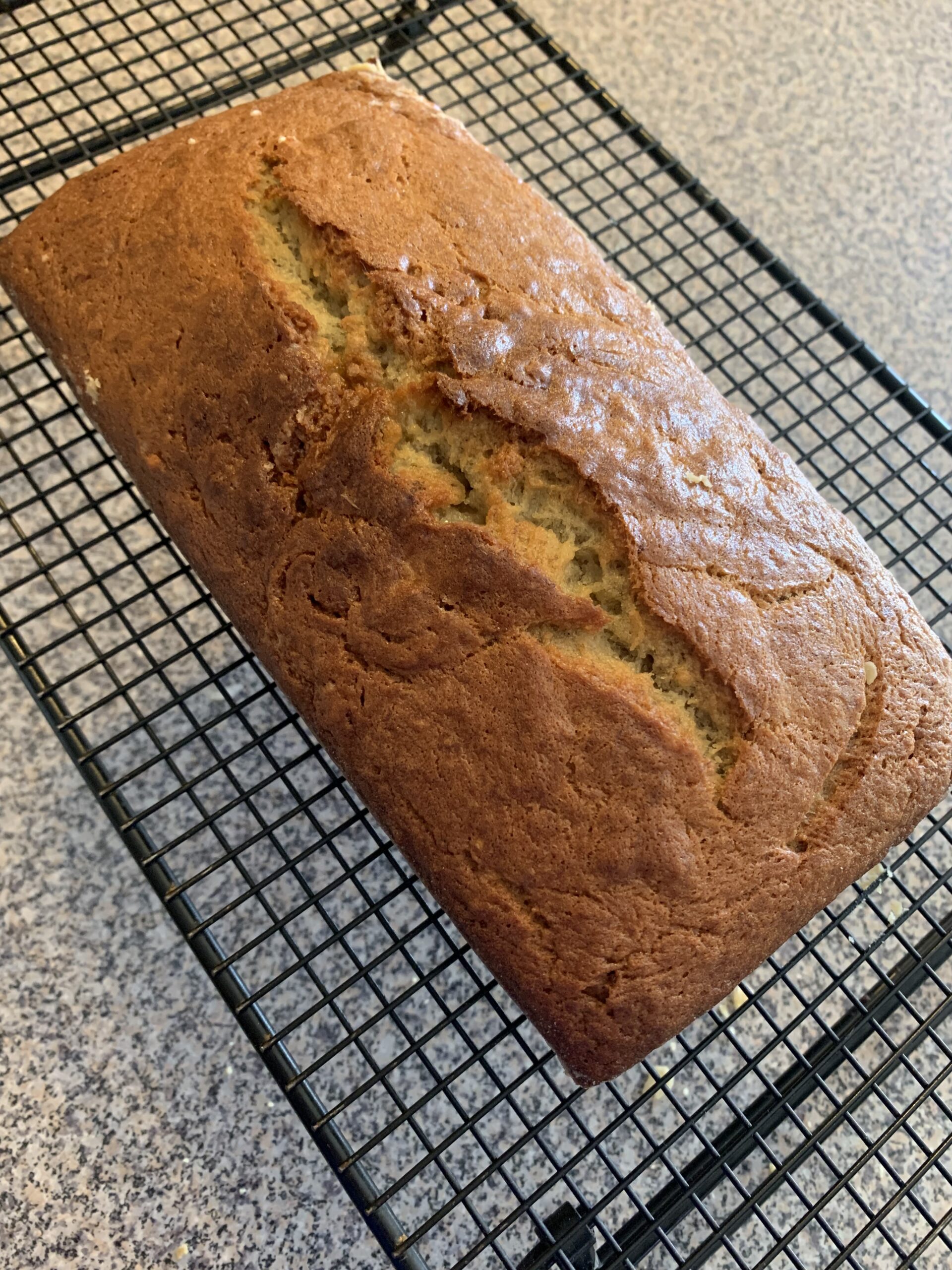 Banana bread on a cooling rack.